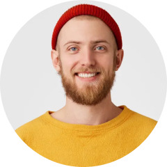 a man smiling in yellow shirt